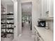 Convenient pantry with custom shelving offers ample space for organized storage of kitchen essentials at 208 Corelli Dr, Nokomis, FL 34275