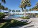 Resort-style pool area with sun loungers and palm trees, perfect for relaxing and enjoying the Florida sunshine at 208 Corelli Dr, Nokomis, FL 34275