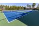 Well-maintained tennis courts surrounded by lush trees, providing a great recreational amenity at 208 Corelli Dr, Nokomis, FL 34275