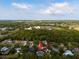 Aerial view with property pin highlighting the home's location near a scenic landscape and city skyline at 214 Whispering Oaks Ct, Sarasota, FL 34232