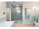 Modern bathroom featuring a glass-enclosed shower, soaking tub, and vanity at 214 Whispering Oaks Ct, Sarasota, FL 34232