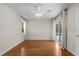 Bedroom with neutral walls, wood floors, and a sliding door to the pool area at 214 Whispering Oaks Ct, Sarasota, FL 34232
