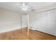 An airy bedroom with wood floors, a ceiling fan, and double closets, offering ample storage at 214 Whispering Oaks Ct, Sarasota, FL 34232