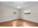 Bedroom with light walls, wood floors, a ceiling fan, and two large windows for natural light at 214 Whispering Oaks Ct, Sarasota, FL 34232