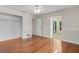 This bedroom has light walls, wood floors, ceiling fan, closet and an outdoor patio door at 214 Whispering Oaks Ct, Sarasota, FL 34232