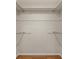 Empty walk-in closet with neutral walls and hardwood floors at 214 Whispering Oaks Ct, Sarasota, FL 34232