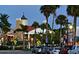 Charming community buildings with palm trees and street parking create a welcoming and vibrant atmosphere at twilight at 214 Whispering Oaks Ct, Sarasota, FL 34232