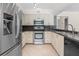 Well-equipped kitchen with stainless steel appliances, granite countertops, and modern cabinetry at 214 Whispering Oaks Ct, Sarasota, FL 34232