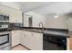 Functional kitchen with stainless steel appliances, granite countertops, and tile flooring at 214 Whispering Oaks Ct, Sarasota, FL 34232