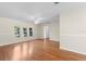 Bright living room featuring hardwood floors, neutral paint, decorative trim, and ample natural light at 214 Whispering Oaks Ct, Sarasota, FL 34232
