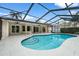 The screened-in pool and patio area offers a private outdoor retreat with clear blue skies at 214 Whispering Oaks Ct, Sarasota, FL 34232