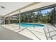 A screened-in pool and deck area provides a relaxing and private outdoor space at 214 Whispering Oaks Ct, Sarasota, FL 34232