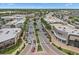 Aerial view of a retail area with palm-lined streets and diverse shopping options on a sunny day at 214 Whispering Oaks Ct, Sarasota, FL 34232