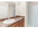 Bathroom with vanity, sink, and shower with patterned curtain at 25525 Lambert Ln, Punta Gorda, FL 33950