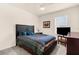Cozy bedroom features a ceiling fan, window, and television on a wooden console at 25525 Lambert Ln, Punta Gorda, FL 33950