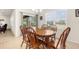Cozy dining area featuring a wood table set, sliding glass doors and bright natural lighting at 25525 Lambert Ln, Punta Gorda, FL 33950