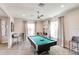 Spacious game room featuring a billiard table, neutral walls, and natural light from multiple windows at 25525 Lambert Ln, Punta Gorda, FL 33950
