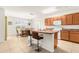 Open kitchen with an island, bar seating, white appliances, and adjacent dining area at 25525 Lambert Ln, Punta Gorda, FL 33950