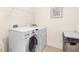 Bright laundry room equipped with modern, front-load washer and dryer at 25525 Lambert Ln, Punta Gorda, FL 33950