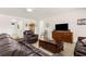 Inviting living room featuring a comfortable sofa, a large TV, and an archway to other rooms at 25525 Lambert Ln, Punta Gorda, FL 33950