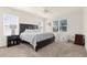 Serene main bedroom with abundant natural light, neutral carpeting, and a view to the backyard at 25525 Lambert Ln, Punta Gorda, FL 33950