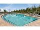 Large community pool with plenty of lounge chairs and lush palm trees at 25525 Lambert Ln, Punta Gorda, FL 33950