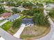 Expansive property outlined in red featuring mature trees, a screened pool, and a well-maintained yard at 2606 Trilby Ave, North Port, FL 34286