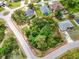 Aerial view of the property showcasing the spacious lot and mature trees at 2606 Trilby Ave, North Port, FL 34286