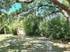 Spacious backyard, surrounded by bamboo trees, with a storage shed at 2606 Trilby Ave, North Port, FL 34286
