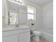 Bright bathroom featuring a white vanity, a large mirror, and a shower/tub combo at 2606 Trilby Ave, North Port, FL 34286
