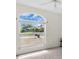 Bedroom featuring a large window overlooking the front yard and a ceiling fan at 2606 Trilby Ave, North Port, FL 34286