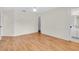 Empty bedroom featuring wood floors and view of the Primary bath at 2606 Trilby Ave, North Port, FL 34286
