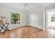 Bedroom with hardwood floors and a large window with natural light at 2606 Trilby Ave, North Port, FL 34286