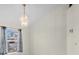 Dining area showcasing a modern chandelier and natural light from the window at 2606 Trilby Ave, North Port, FL 34286