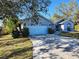 Well-maintained single-story home featuring an attached garage and a long driveway, offering curb appeal at 2606 Trilby Ave, North Port, FL 34286