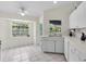 An eat-in kitchen offers plenty of natural light and white cabinets with tile flooring at 2606 Trilby Ave, North Port, FL 34286