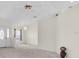 Inviting living area with neutral carpet, bright walls, a chandelier, and a front door view at 2606 Trilby Ave, North Port, FL 34286