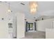 Open-concept living area featuring neutral carpet, high ceilings, and glass doors leading to backyard at 2606 Trilby Ave, North Port, FL 34286