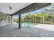 Screened pool area featuring concrete tile, a ceiling fan, and access to lush backyard, offering privacy at 2606 Trilby Ave, North Port, FL 34286