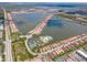 Breathtaking aerial view of the community highlighting waterfront homes, a clubhouse, and scenic surroundings at 288 Soliera St, Nokomis, FL 34275