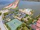 Beautiful aerial view of community amenities and waterfront homes with red tile roofs at 288 Soliera St, Nokomis, FL 34275