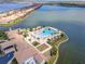 Aerial view of community clubhouse and pool area with lush landscaping and a waterfront setting at 288 Soliera St, Nokomis, FL 34275