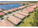 An aerial view showcases homes by a lake with a fountain, offering serene waterfront living at 288 Soliera St, Nokomis, FL 34275