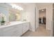 Bathroom with a large mirror, white vanity with drawers, and doorway to a walk-in closet at 288 Soliera St, Nokomis, FL 34275