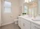 Bright bathroom with modern vanity, white cabinets, and tiled floors at 288 Soliera St, Nokomis, FL 34275