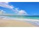 Beautiful beach with clear turquoise water and soft, white sand under a bright blue sky with fluffy clouds at 288 Soliera St, Nokomis, FL 34275