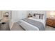 Modern bedroom with a large bed, neutral walls and a desk next to the bed at 288 Soliera St, Nokomis, FL 34275