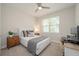 Cozy bedroom with a ceiling fan, window with blinds, and a computer desk at 288 Soliera St, Nokomis, FL 34275