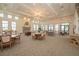 Elegant clubhouse interior with fireplace, chandelier, and various seating arrangements for residents to enjoy at 288 Soliera St, Nokomis, FL 34275