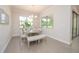 Bright dining room with a modern table, bench seating, and large windows overlooking the yard at 288 Soliera St, Nokomis, FL 34275